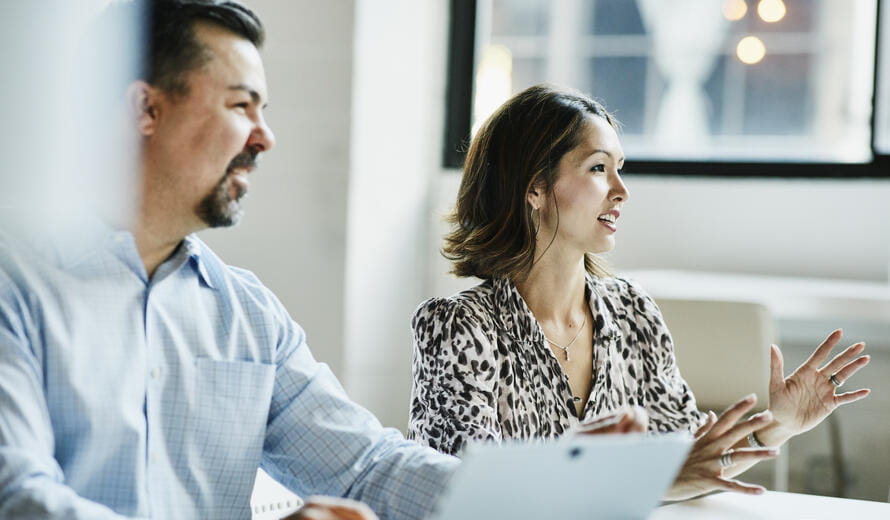 Businesswoman leading team meeting in coworking office