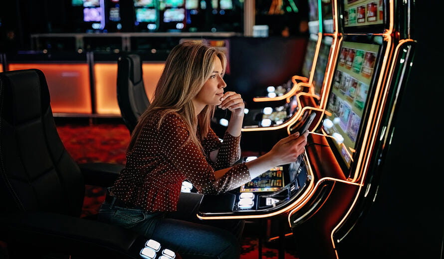 Women gambling on slot machinery