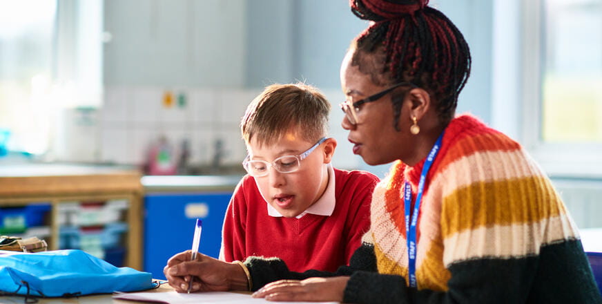 Teacher and student reviewing homework