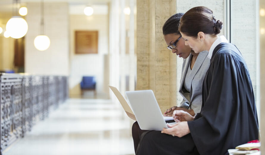 2 people on laptops