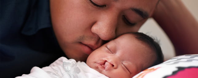 dad sleeping with his baby